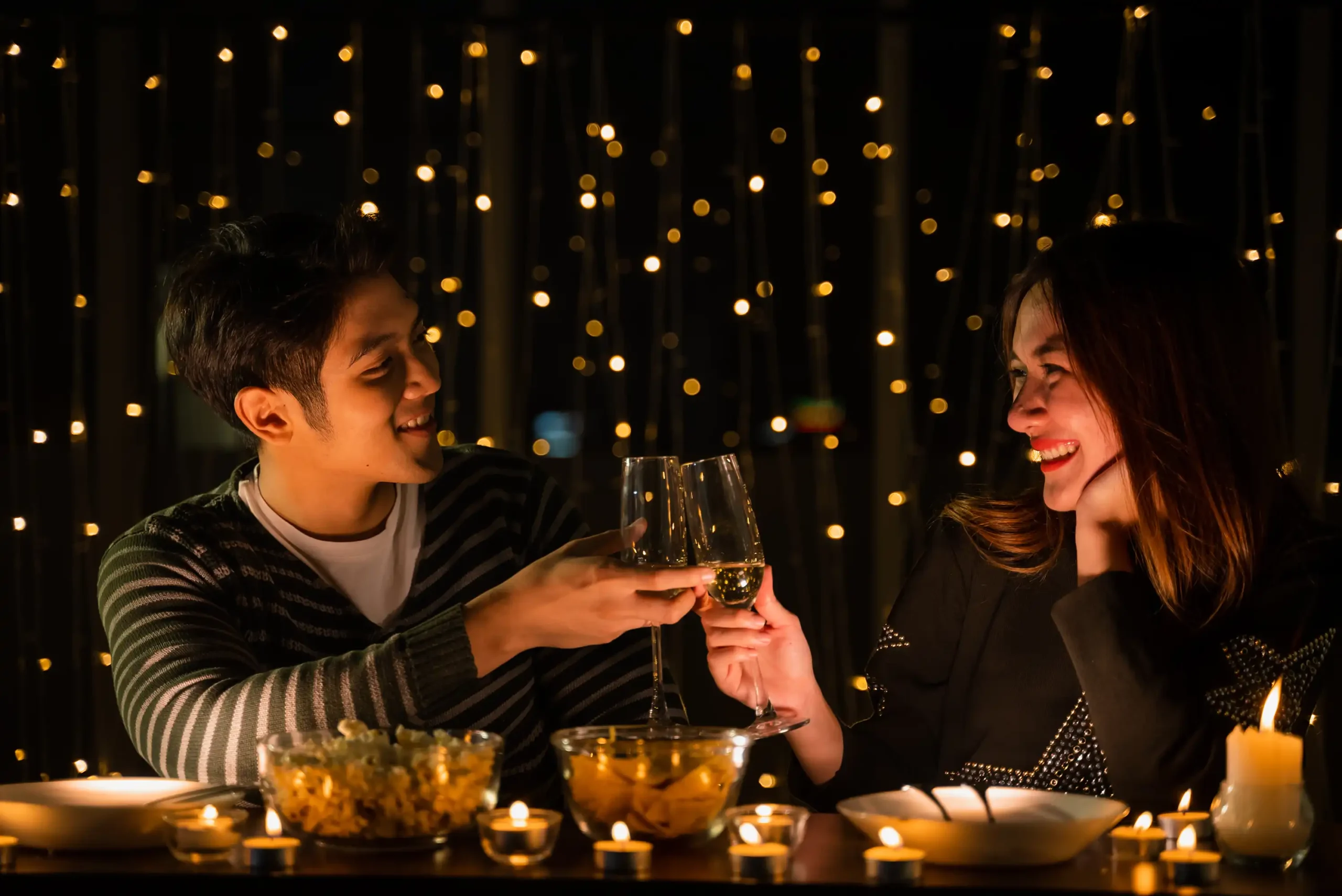 Couple toasting wine at a romantic candlelit dinner